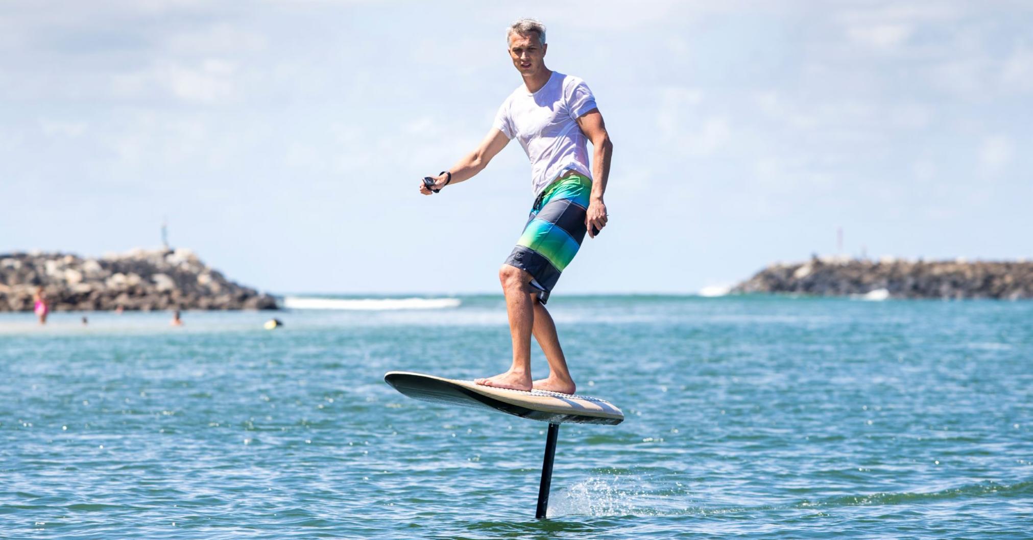 Surfboard floating above water store