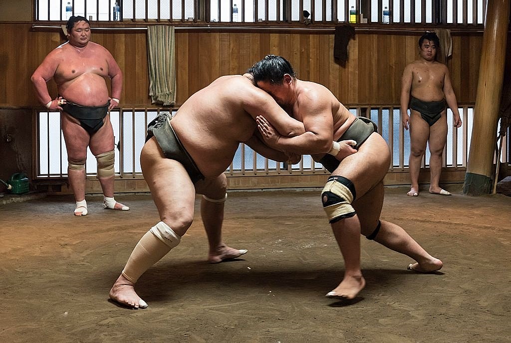 Sumo wrestlers grappling