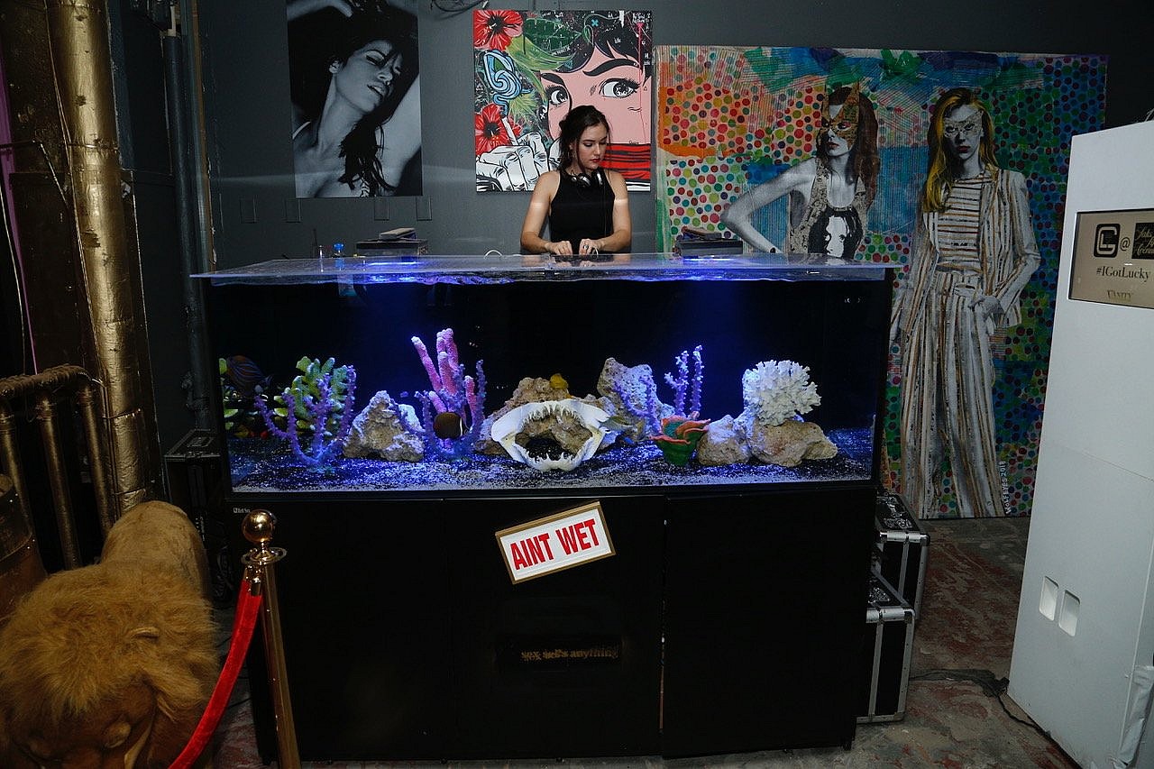 GLDC (1) Sasha Grey doing a surprise DJ set on GLDC's custom built saltwater fish tank DJ booth during Fashion Week at Saks.