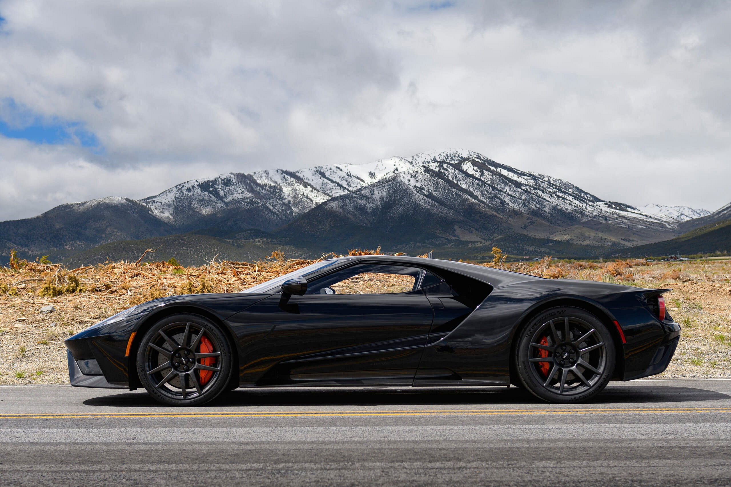 Black and orange Ford GT profile on road