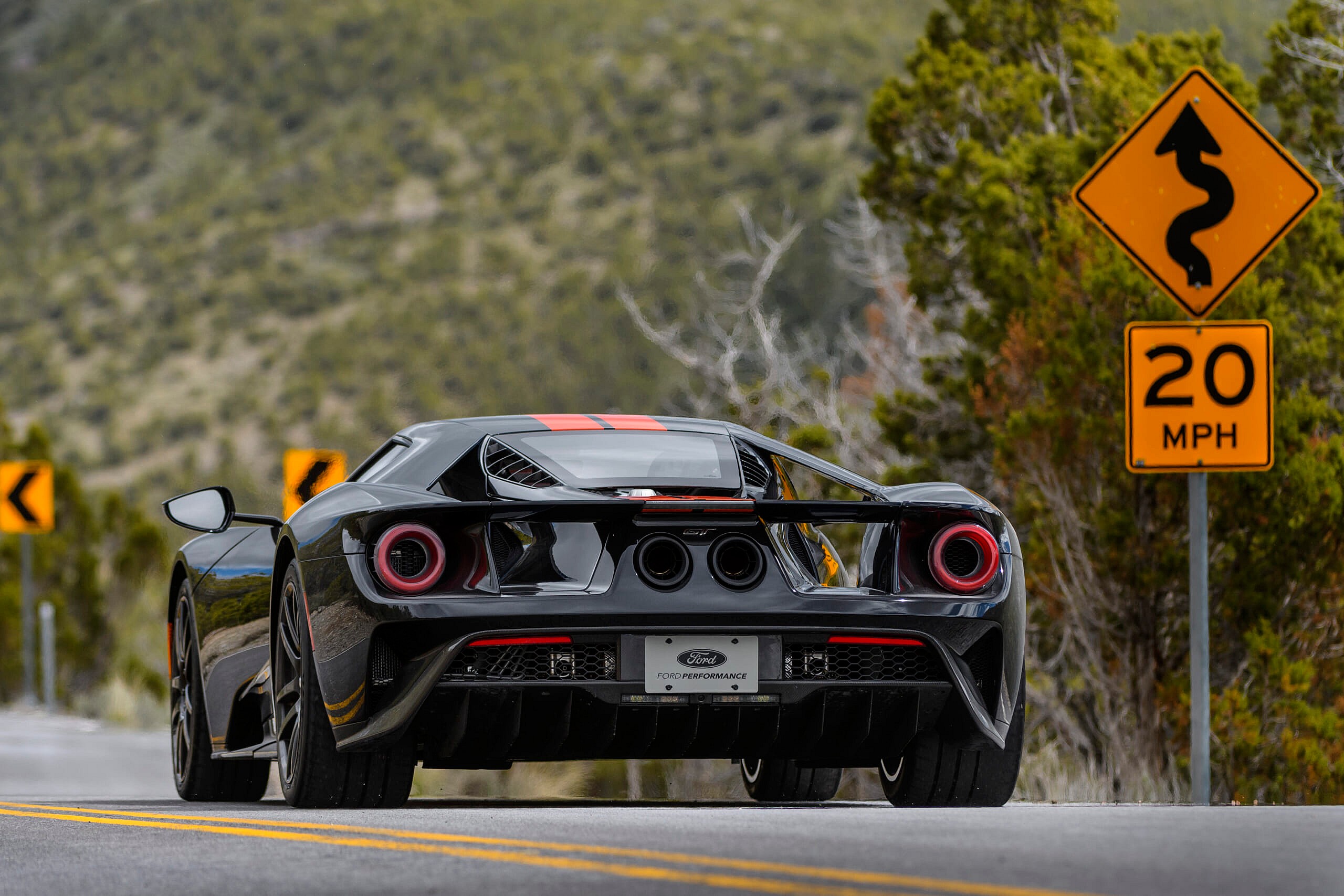 Black and orange Ford GT on road