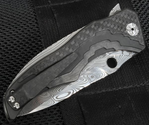 Brian Tighe ZipTighe Damascus Carbon Fiber folding knife - folded.jpg It opens with a quick snap and locks in place