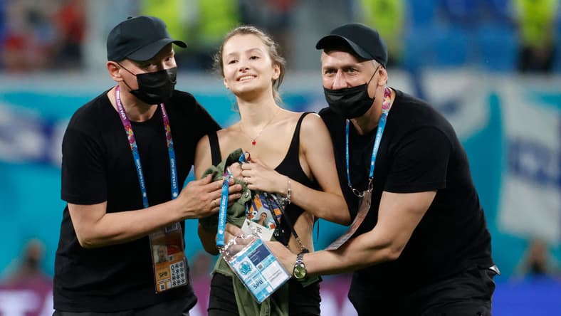 Stadium security stop a pitch invader during the UEFA EURO 2020 Group B football match between Finland and Belgium at Saint Petersburg Stadium in Saint Petersburg