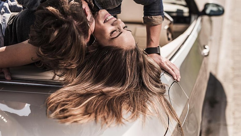 young couple in car promo
