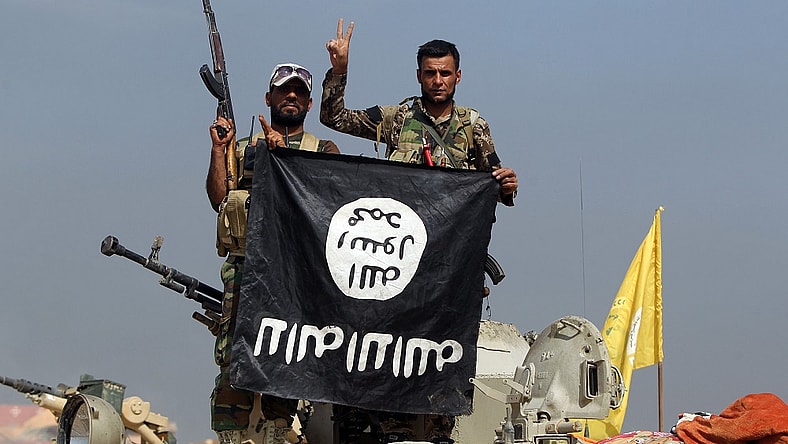 Iraqi fighters ISIS flag Getty
