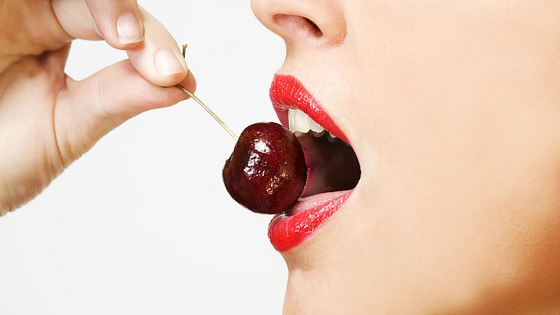 woman eating cherry