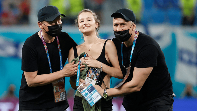 Stadium security stop a pitch invader during the UEFA EURO 2020 Group B football match between Finland and Belgium at Saint Petersburg Stadium in Saint Petersburg