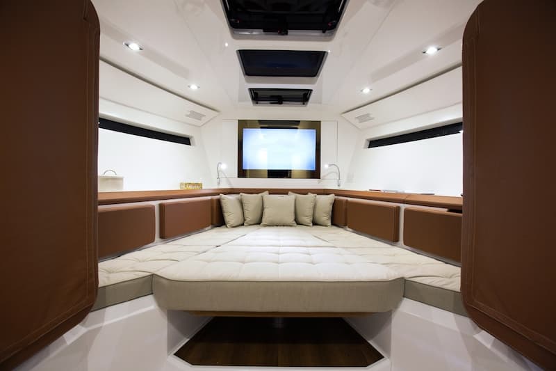 Even the stateroom transforms with a rising table (Photo: Evo Yachts)