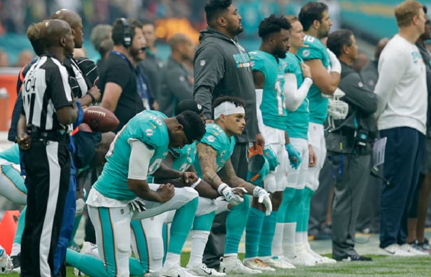 kneeling-dolphins-getty Miami Dolphins kneeling on Oct. 1