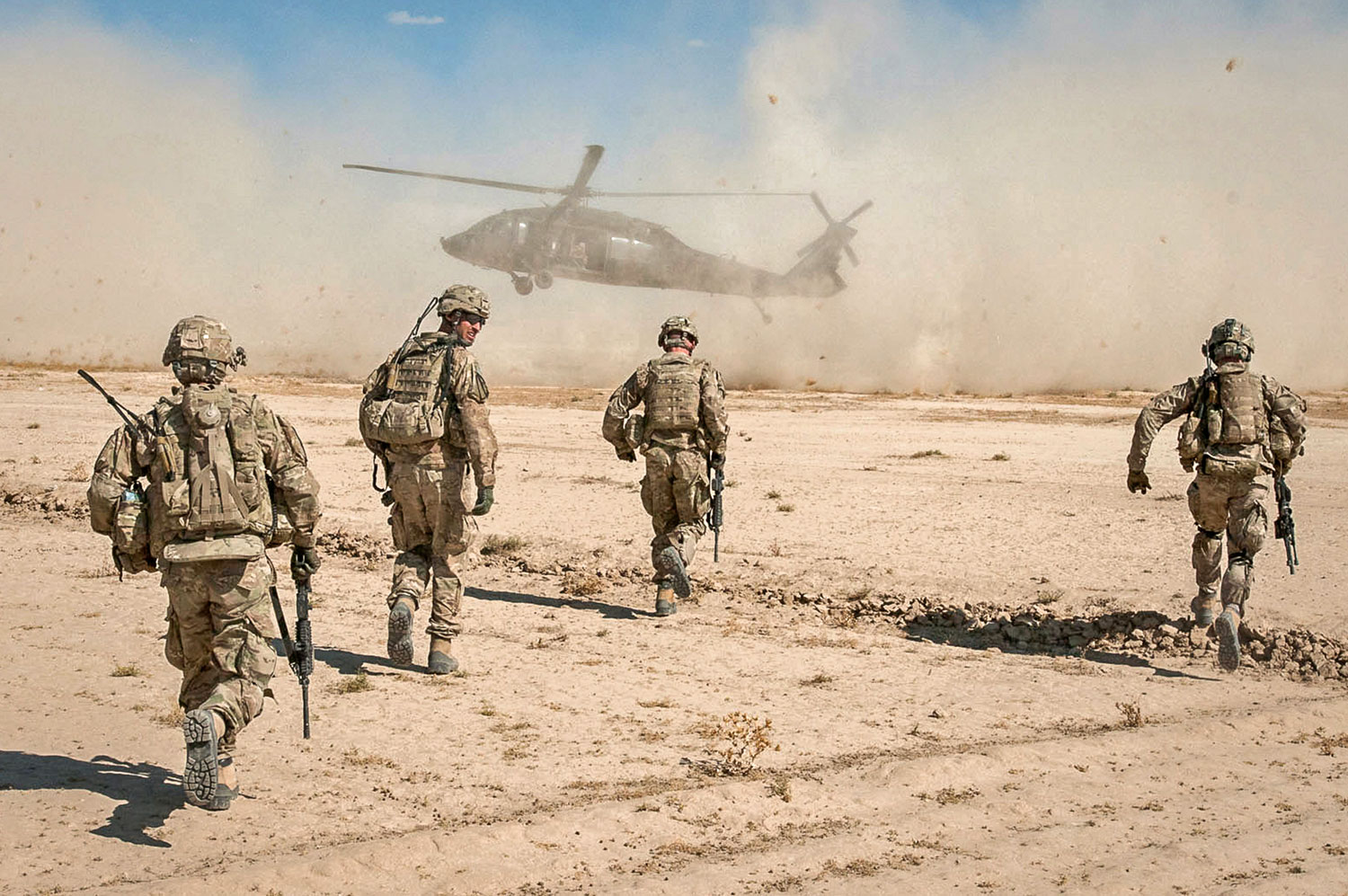 Battlefield Circulation - GHAZNI PROVINCE, Afghanistan — 1st Cavalry Division Deputy Commanding General, Brig. Gen. Gary Volesky (right) and members of his personal security detail run to their UH-60 Black Hawk Oct. 19, 2011. Volesky and his team were conducting a battlefield circulation to several ISAF positions south of Kabul in the Deh Yak and Mata Khan districts.