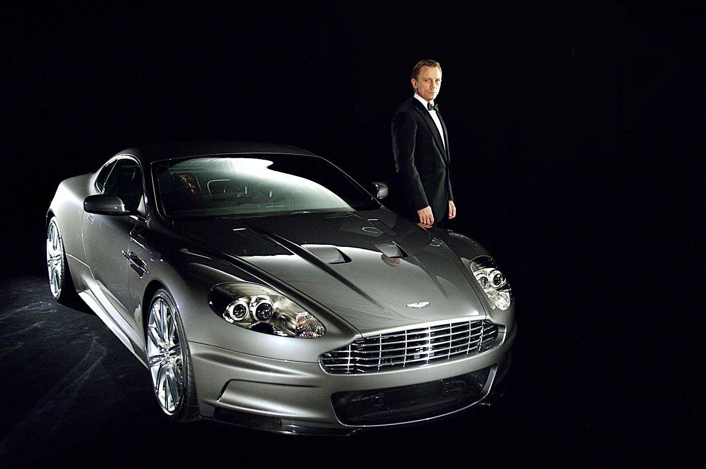 Casino Royale (2006) – DB5, Aston Martin DBS V12 - The Driver: A craggy Daniel Craig was tapped to lead this origin story, a reinvention of the brand absent invisible cars and shoe-knives. This Bond fought with savage strength but ultimately succumbed to the wiles of Eva Green (who wouldn’t?).The Car: While the movie as a whole was a revolution, the car was very much an evolution: a tuned, lightened version of Aston’s DB9 warhorse.The Evolutionary Leap: The new Bond, soulful and brooding, didn’t have to rely so much on gadgets and grenades. Its role diminished, the Aston made a brief appearance before getting flipped in one of the greatest single-car crashes in cinema history.