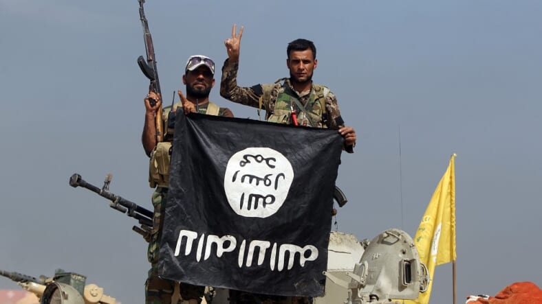 Iraqi fighters ISIS flag Getty