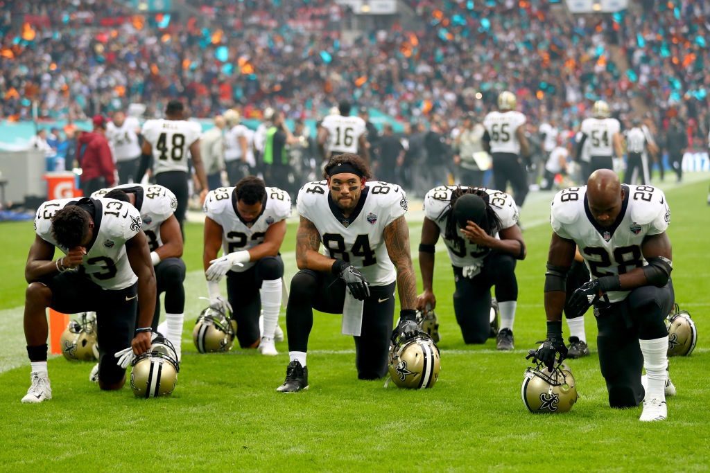 New Orleans Saints players and team kneel prior to the NFL match between New Orleans Saints and Miami Dolphins at Wembley Stadium on October 1, 2017 in London, England.