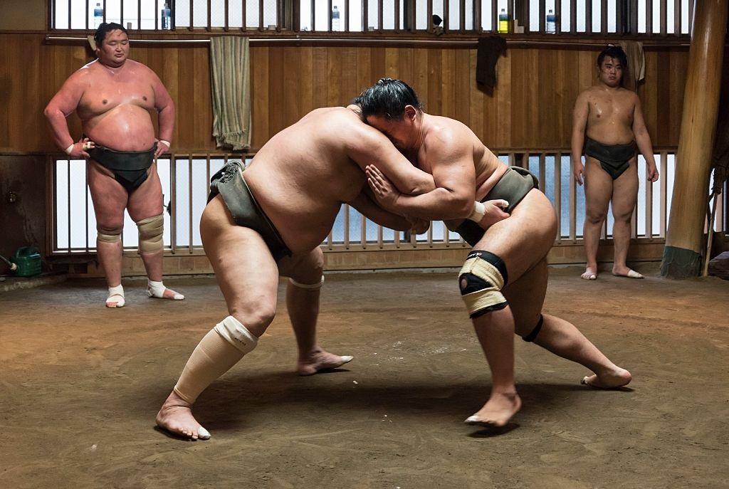 Sumo wrestlers grappling