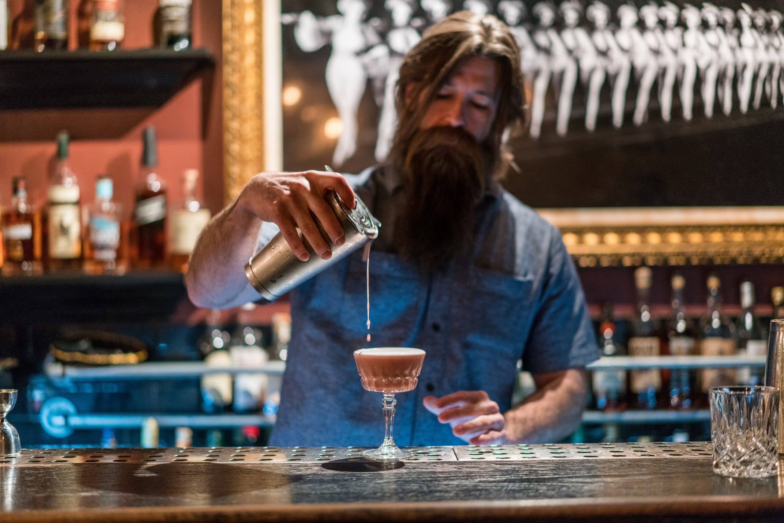 The Laundry Room barman pouring Berried In Sin cocktail by Charles Sicuso