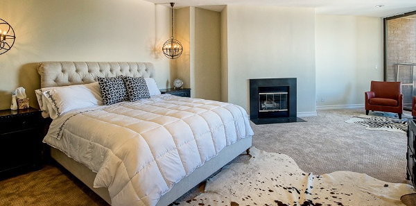 The master bedroom with animal skin and obligatory L.A. fireplace