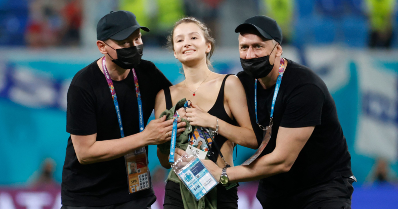 Stadium security stop a pitch invader during the UEFA EURO 2020 Group B football match between Finland and Belgium at Saint Petersburg Stadium in Saint Petersburg